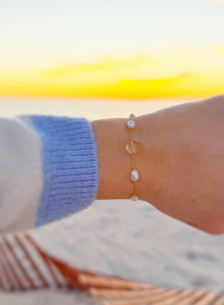 Sun and snow adjustable bracelet on a wrist at sunset