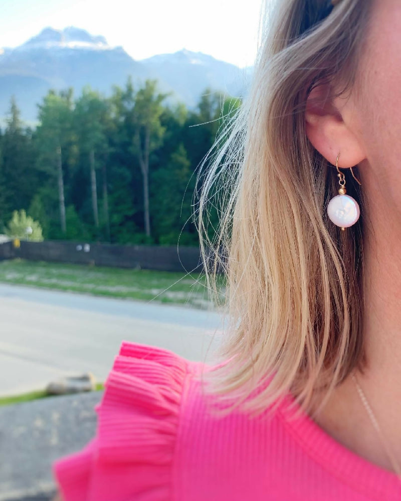 newport pearl earrings gf on ear with mountains in background