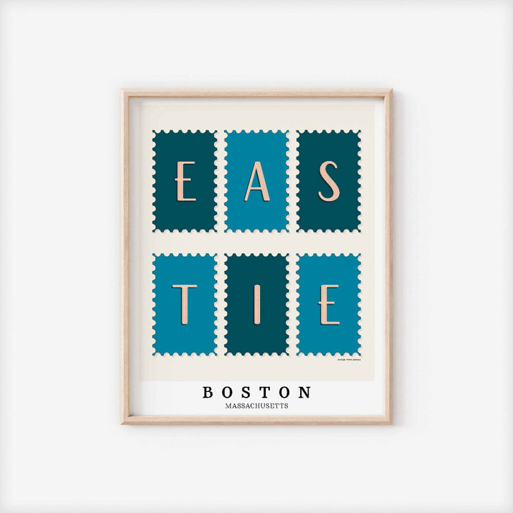 A framed picture of postage stamps featuring the Eastie neighborhood in Boston, Massachusetts drawn in a unique lettering style. Artwork has a blue and white color scheme