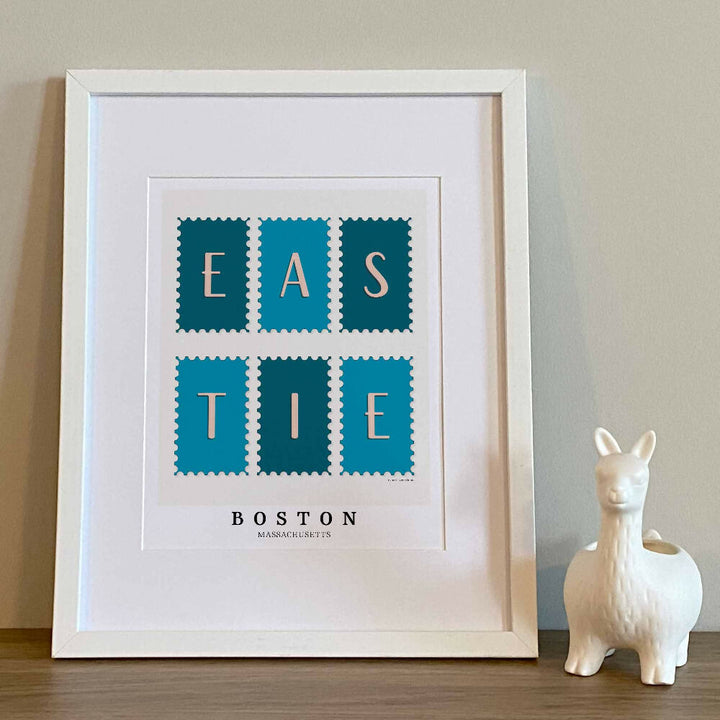 Boston wall art showing a Eastie postage stamp collection design drawn with expressive lettering in blue and white tones.