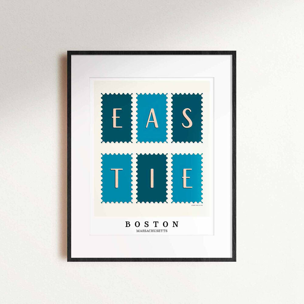 A framed picture of postage stamps featuring the Eastie neighborhood in Boston, Massachusetts drawn in a unique lettering style. Artwork has a blue and white color scheme