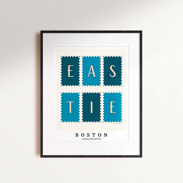 A framed picture of postage stamps featuring the Eastie neighborhood in Boston, Massachusetts drawn in a unique lettering style. Artwork has a blue and white color scheme