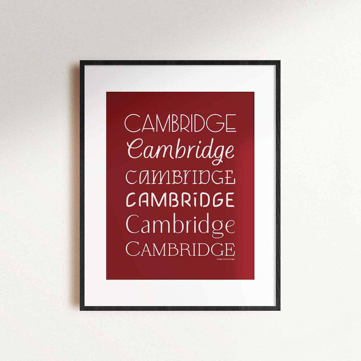 A framed picture of the word "Cambridge" drawn in various lettering styles. Artwork has a red and white color scheme